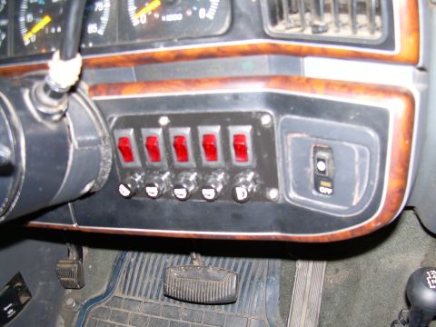 1991 Ford Bronco - Dashboard interior showing auxiliary switches and part of the steering column.