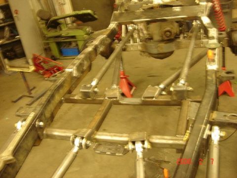 1991 Ford Bronco - Custom fabricated vehicle frame with suspension components and welding visible.