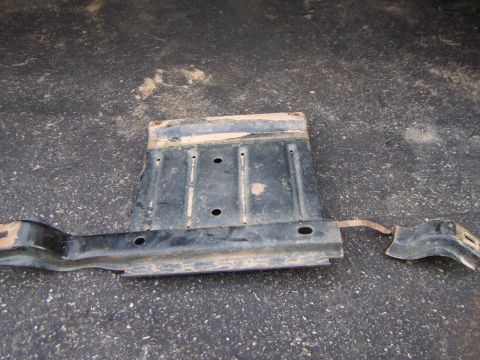 2003 Jeep Wrangler - This metal part from a vehicle's undercarriage is shown resting on a dark, textured surface.