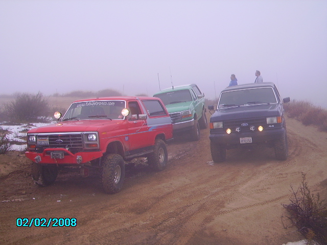 Red SUV with aftermarket bumper and lights, 3/4 front view