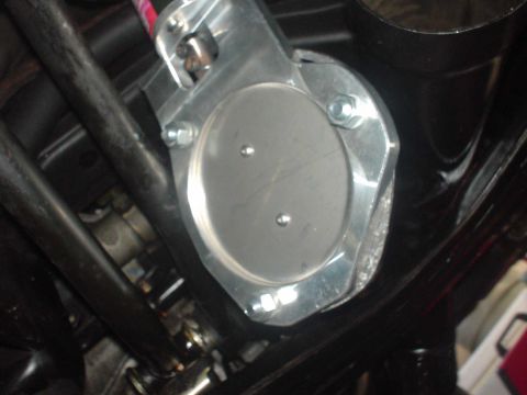1993 Mazda MX-6 - A close-up view of a throttle body assembly, showing metallic components and fasteners.