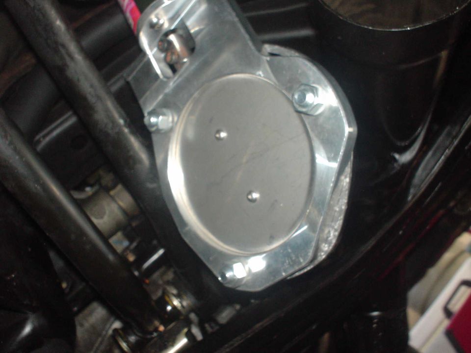 Close-up of a silver throttle body with two bolts, mounted on black tubing