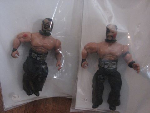 1991 Ford Bronco - Two wrestling action figures are packaged individually, with one figure showing a red mark on its left shoulder.
