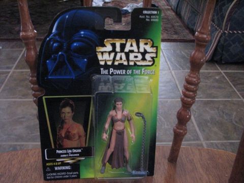 1991 Ford Bronco - A Star Wars action figure is displayed in its original packaging on a wooden surface.