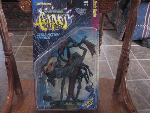 1991 Ford Bronco - Todd McFarlane's Total Chaos Brain Drain action figure, a collectible toy, is displayed in its original packaging.