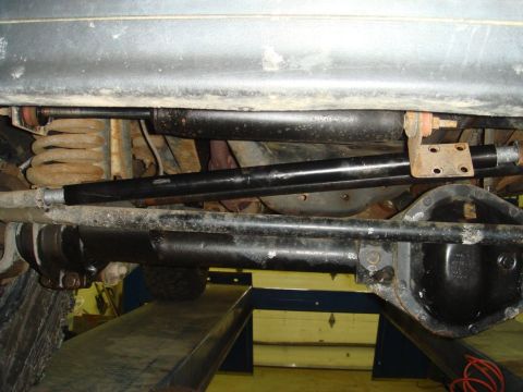 1996 Ford Bronco - Close-up of the undercarriage, focusing on the steering and suspension system components.