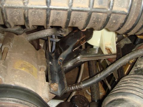 1996 Ford Bronco - Close-up view of engine bay components including an alternator and various hoses.