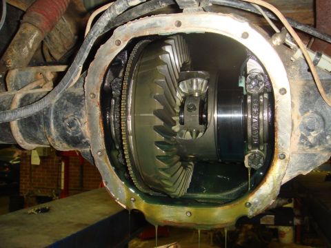 1996 Ford Bronco - Opened differential housing with visible ring and pinion gears, showing fluid leakage.