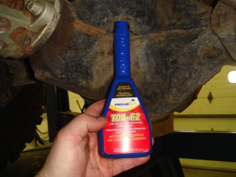 1996 Ford Bronco - A bottle of Prolab TDA-62 limited-slip differential treatment is shown near a vehicle's rusty differential.