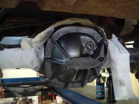 1996 Ford Bronco - Differential cover with "ROCKCRUSHER" text, taped off for service.