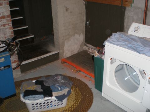 1995 Ford F-150 - A laundry room scene a washing machine, a basket of clothes, and a set of stairs.
