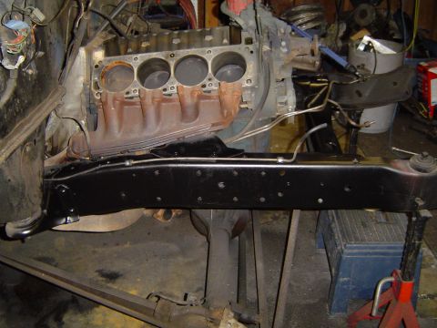 1979 Ford Bronco - Close-up view of an engine block and the vehicle's frame, likely undergoing repair or restoration.