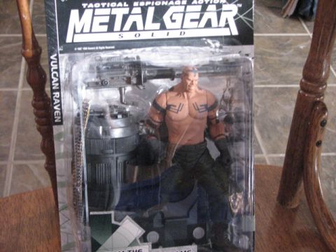 1991 Ford Bronco - Action figure packaging for Metal Gear Solid's Vulcan Raven, including accessories.