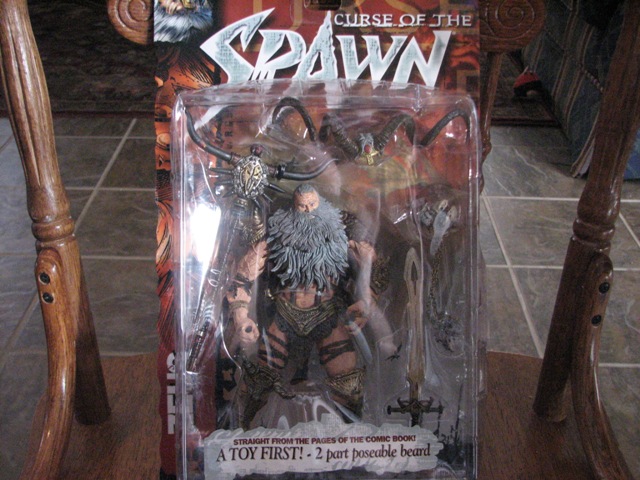 Spawn action figure in plastic packaging, with a large beard and sword