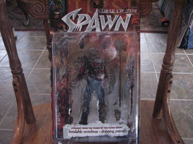 Spawn action figure in "Curse of the Spawn" packaging with text "bendable vertebrae ", "dripping entrails"