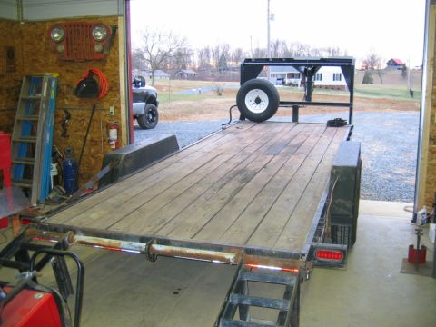 1992 Ford Mustang - A trailer sits in a garage, with a truck partially visible in the background.