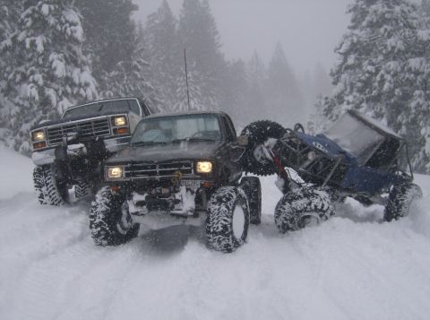1986 Ford Bronco - Three heavily modified trucks are stuck in the snow during a winter outing.