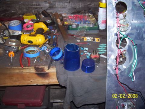 1978 Ford Bronco - A collection of tools and electrical parts are laid out on a workbench, ready for installation or repair.