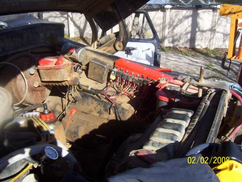 1978 Ford Bronco - The engine bay of a 1978 Ford Bronco shows its master cylinder, fuse box, and wiring harness.