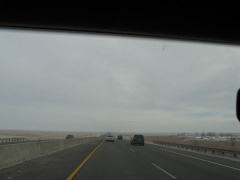 1995 Ford Bronco - View from inside a vehicle traveling on a multi-lane highway with other cars on the road.