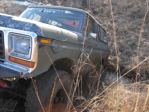 1995 Ford Bronco - This 1980s Ford Bronco is stuck in the mud while off-roading.