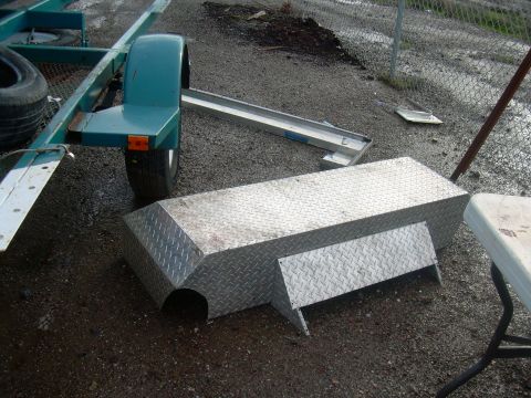 1991 Ford Bronco - Diamond plate toolbox and trailer fender with tire on gravel surface.