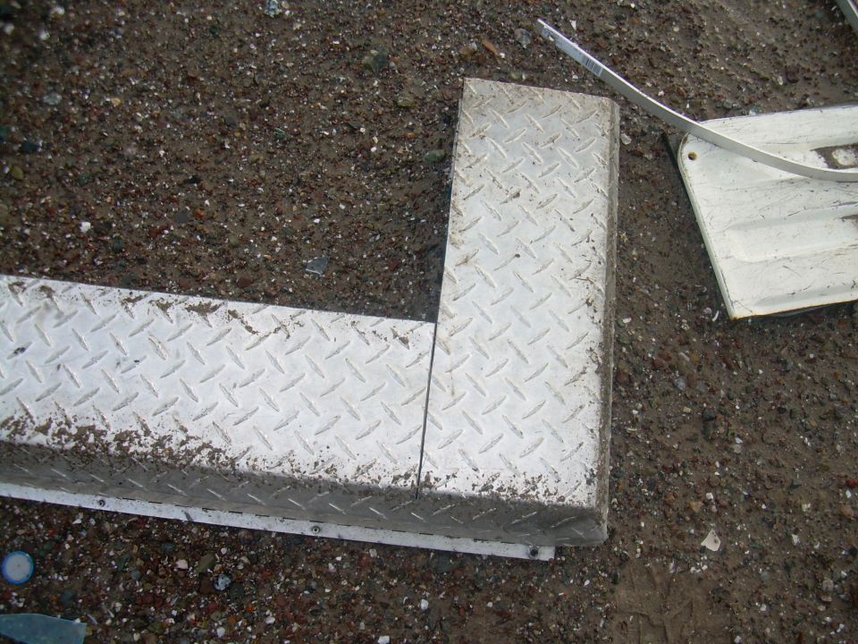 Diamond plate metal trim piece on the ground