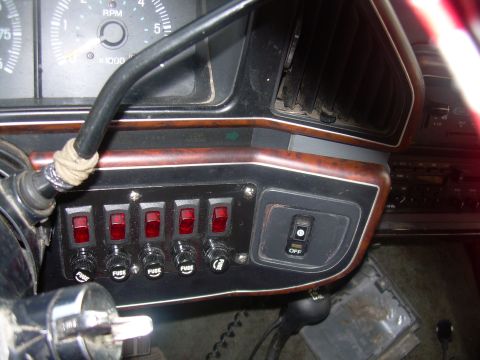 1991 Ford Bronco - Interior view of a vehicle's dashboard, showing auxiliary switches and a gauge cluster.