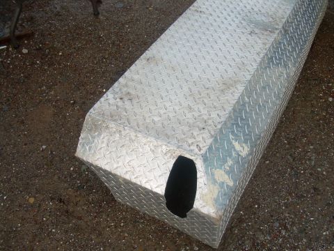 1991 Ford Bronco - Diamond plate toolbox with a cutout on the side, resting on gravel.