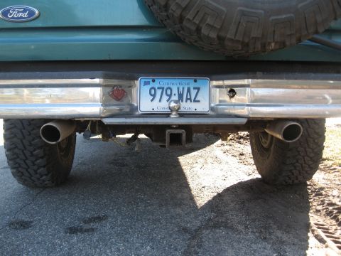 1996 Ford Bronco - Rear view of a 1996 Ford Bronco, dual exhaust pipes and a spare tire mounted externally.