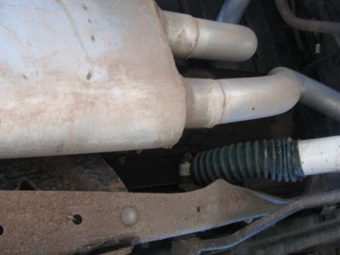1996 Ford Bronco - Underside view of a vehicle's dual exhaust system, showing the muffler and piping.