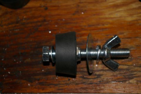 1986 Ford Bronco - Close-up of a bolt assembly with a rubber bumper and wing nut, likely for mounting equipment.