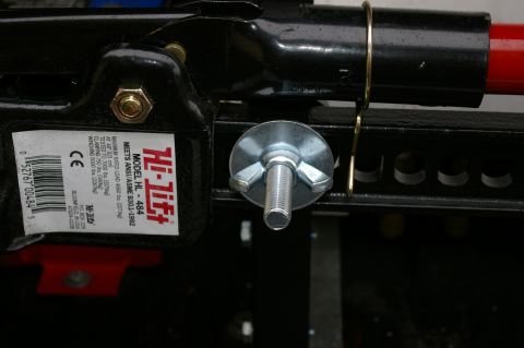 1986 Ford Bronco - A Hi-Lift jack model HL-484 is shown with a wingnut bolt securing a part of the jack.