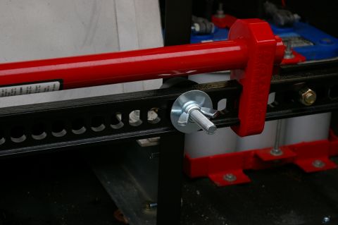 1986 Ford Bronco - A red hi-lift jack is mounted to a black rack, with visible text on a label.