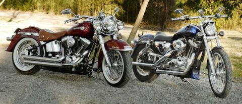 2005 Ford Crown Victoria - Two motorcycles are parked side-by-side on a gravel surface, with trees and foliage in the background.