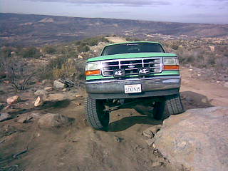 1996 Ford Bronco - This 1996 Ford Bronco navigates a rough, off-road path with rocky obstacles.