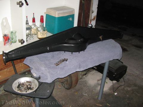 1968 Ford Mustang - A black rear axle assembly is shown on a table, with a small dish of bolts nearby.