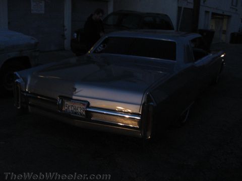 1968 Ford Mustang - Rear view of a 1967 Cadillac Coupe de Ville parked outdoors at dusk.