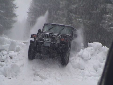 2005 Jeep Wrangler - Jeep Wrangler navigating a snow-covered road during a blizzard.