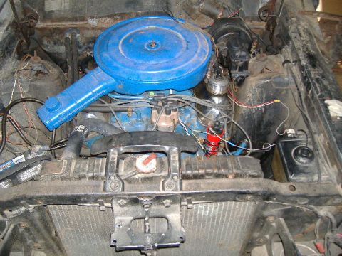 1969 Ford Torino - Close-up view of a vehicle's engine bay, showing the air filter, radiator, and battery.