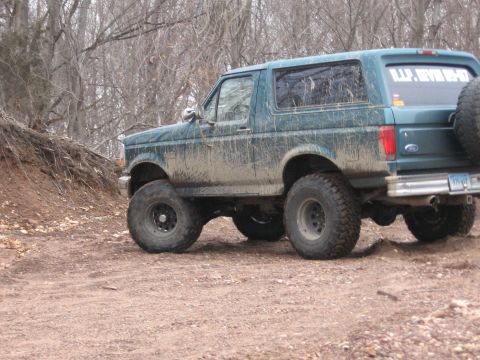 1996 Ford Bronco - This lifted Ford Bronco is covered in mud, suggesting it has been used for off-roading.