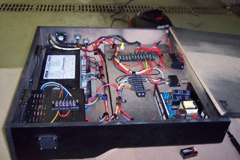 2001 Ford Crown Victoria - A view inside an open electrical enclosure revealing intricate wiring and electronic components.