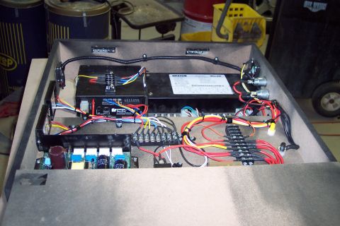 2001 Ford Crown Victoria - Close-up view of an electronic control unit, showing its complex wiring and terminal blocks.
