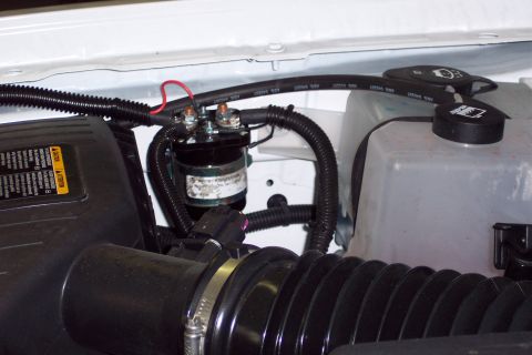 2001 Ford Crown Victoria - Close-up view of engine bay components including a relay and coolant reservoir.