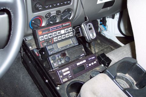 2001 Ford Crown Victoria - Multiple communication devices are installed in the vehicle's center console area.