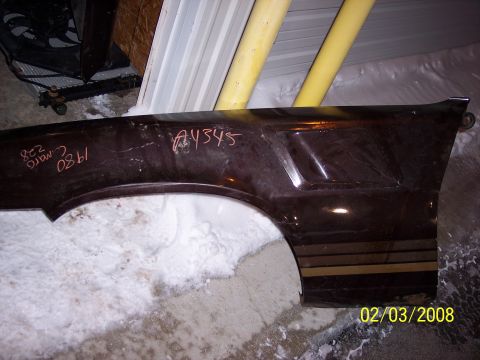 1989 Ford Bronco - Fender with handwritten markings, possibly from a 1980s Camaro, is shown in storage.