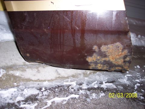 1989 Ford Bronco - This photo shows the lower body panel of a vehicle with rust and water damage, not Camaro parts.
