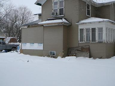 1997 Mercury Grand Marquis - A house foundation is visible with a truck parked in the snowy background.