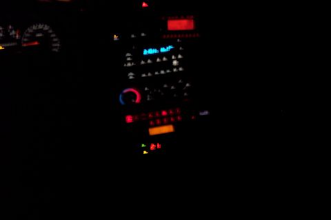 2001 Ford Crown Victoria - Illuminated dashboard and center console of a car at night.