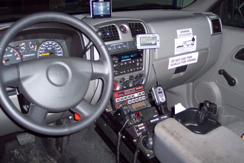 2001 Ford Crown Victoria - The interior of a GMC truck is shown, equipped with various communication devices and a warning label.